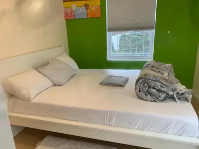 a bed in a room with a green wall at The Green Place of Newark in Newark