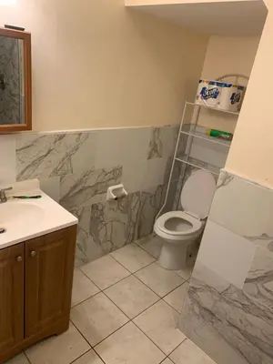 a bathroom with a toilet and a sink at The Green Place of Newark in Newark