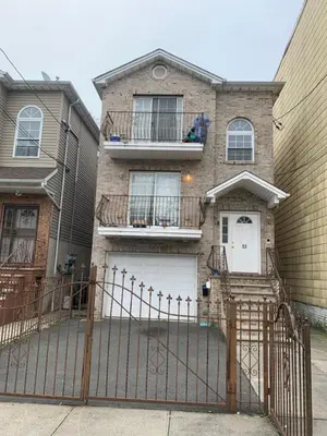 a brick house with a gate in front of it at The Green Place of Newark in Newark