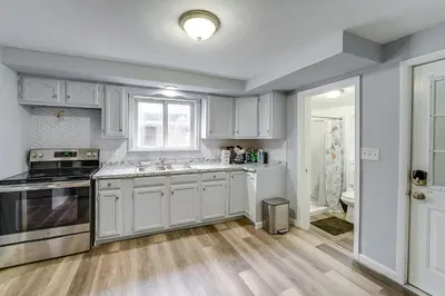 a kitchen with white cabinets and a sink at Updated Minersville Townhome by ATV Trail! in Mount Pleasant