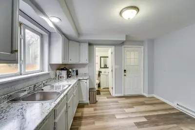 a kitchen with white cabinets and a sink at Updated Minersville Townhome by ATV Trail! in Mount Pleasant