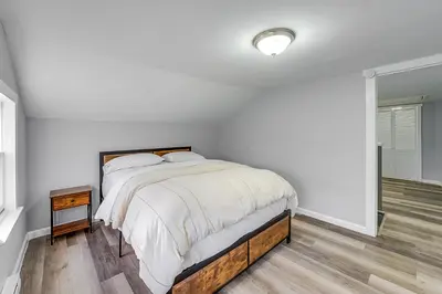 a white bedroom with a bed and a window at Updated Minersville Townhome by ATV Trail! in Mount Pleasant