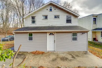 a white house with a garage in a yard at Updated Minersville Townhome by ATV Trail! in Mount Pleasant
