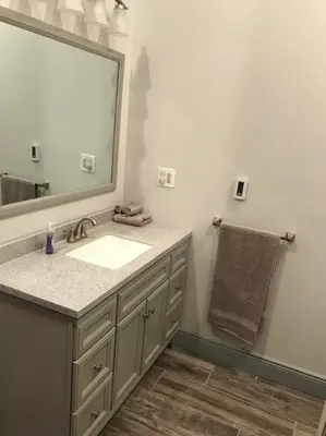 a bathroom with a sink and a large mirror at The Cast Iron Lady in Wyalusing