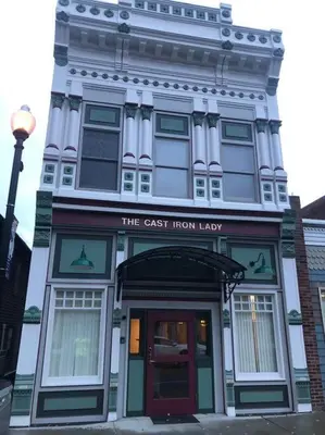 a tall white building with a sign on it at The Cast Iron Lady in Wyalusing