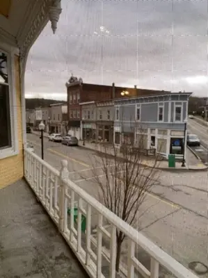 a view of a street from a building with a white fence at Small Town Hideaway in Wyalusing