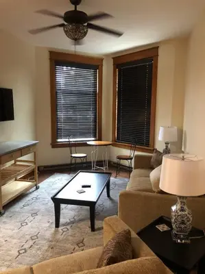 a living room with a couch and a ceiling fan at Small Town Hideaway in Wyalusing