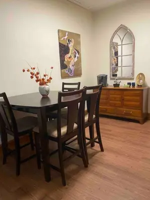 a dining room table with chairs and a vase on it at Small Town Hideaway in Wyalusing