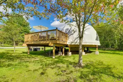 a yurt with a deck and a tent at Unique Escapes - 007 Geodome in Monticello