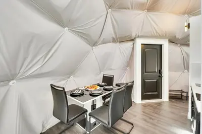 a dining room with a table in a tent at Unique Escapes - 007 Geodome in Monticello