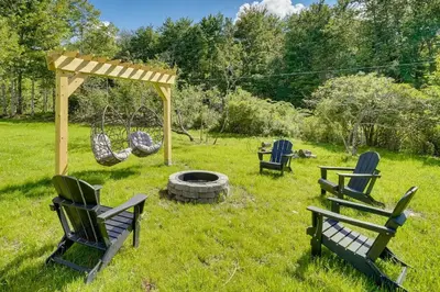 a group of chairs and a swing in a yard at Unique Escapes - 007 Geodome in Monticello