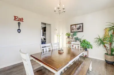 a dining room with a table and potted plants at Spacious Ewing Township Home Home Gym and Deck!