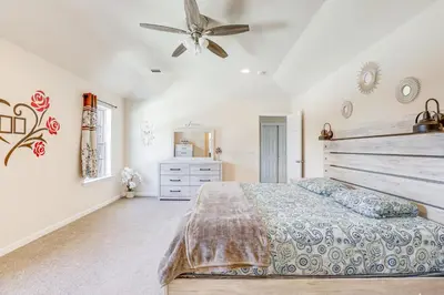 a bedroom with a bed and a ceiling fan at Spacious Ewing Township Home Home Gym and Deck!