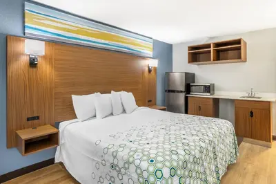 a hotel room with a bed and a kitchen at HomeTowne Studios by Red Roof Lancaster in Lancaster