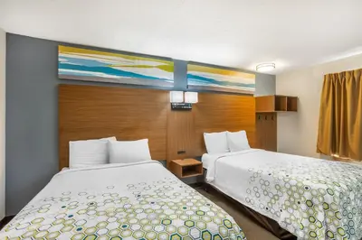 a hotel room with two beds and a window at HomeTowne Studios by Red Roof Lancaster in Lancaster