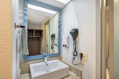 a bathroom with a sink and a phone on the wall at HomeTowne Studios by Red Roof Lancaster in Lancaster