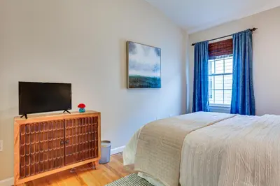a bedroom with a bed and a flat screen tv at Bayfront New Jersey Escape about 13 Mi to Times Square in Bayonne