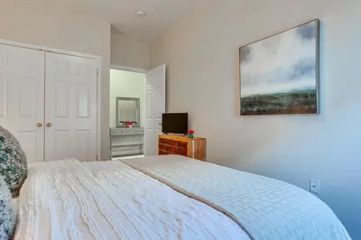 a bedroom with a bed and a desk with a computer at Bayfront New Jersey Escape about 13 Mi to Times Square in Bayonne