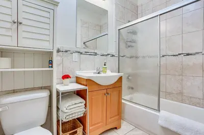a bathroom with a toilet sink and a shower at Bayfront New Jersey Escape about 13 Mi to Times Square in Bayonne