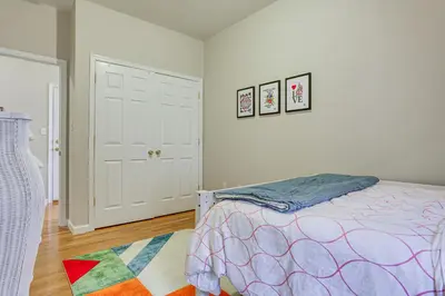 a bedroom with a bed and two pictures on the wall at Bayfront New Jersey Escape about 13 Mi to Times Square in Bayonne
