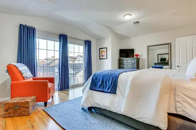 a bedroom with a bed and a chair and a window at Bayfront New Jersey Escape about 13 Mi to Times Square in Bayonne