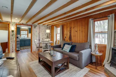 a living room with a couch and a fireplace at Cozy Lake Wallenpaupack Cabin with Community Perks in Lake Ariel