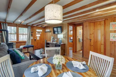 a living room with a table and chairs at Cozy Lake Wallenpaupack Cabin with Community Perks in Lake Ariel