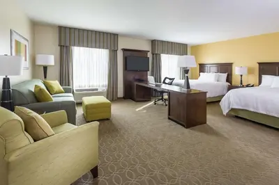 a large hotel room with two beds and a desk at Hampton Inn & Suites Philadelphia Montgomeryville in North Wales