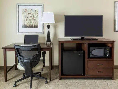 a room with a desk with a computer and a television at Hampton Inn & Suites Philadelphia Montgomeryville in North Wales