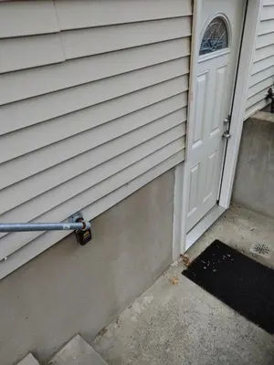 a white door with a handle next to a doorstep at Guest house in a quiet peaceful area. in Mariners Harbor