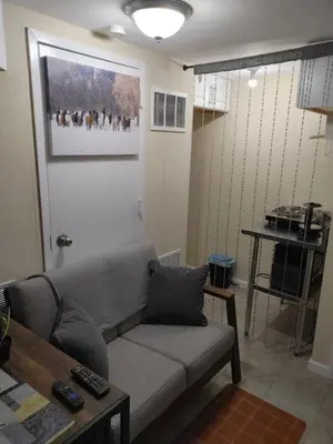 a living room with a couch and a table at Guest house in a quiet peaceful area. in Mariners Harbor