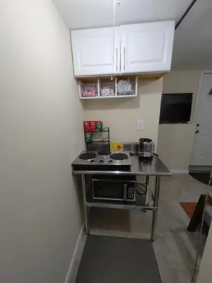 a kitchen with a stove and a counter top at Guest house in a quiet peaceful area. in Mariners Harbor