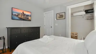 a bedroom with a white bed and a dresser at The Outpost Camelback Walk to Ski, Swim, and Fun! in Tannersville