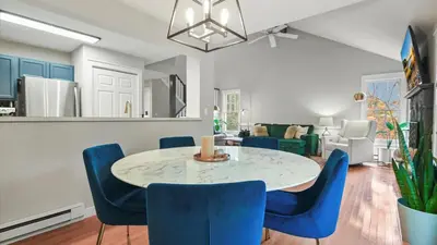 a dining room with a table and blue chairs at The Outpost Camelback Walk to Ski, Swim, and Fun! in Tannersville