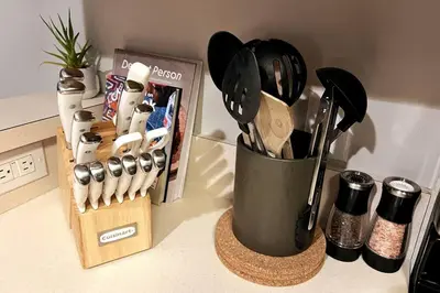 a container of kitchen utensils sitting on a counter at The Outpost Camelback Walk to Ski, Swim, and Fun! in Tannersville