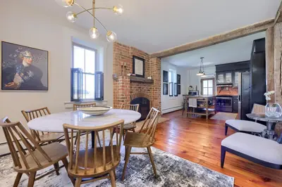 a dining room and living room with a table and chairs at The Tannery in Lancaster