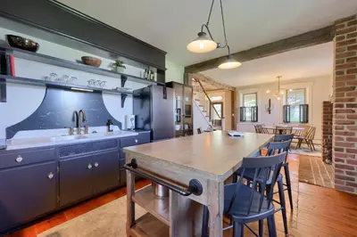 a kitchen with a wooden table and blue cabinets at The Tannery in Lancaster