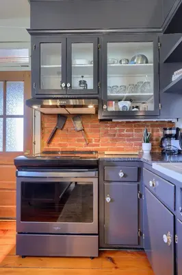 a kitchen with black cabinets and a stove top oven at The Tannery in Lancaster