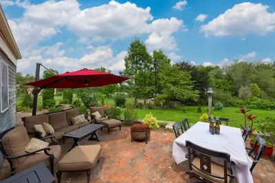 a patio with a table and chairs and an umbrella at The Tannery in Lancaster