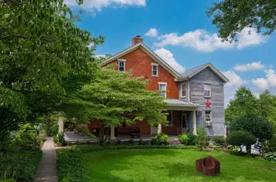 a red brick house with a tree in the yard at The Tannery in Lancaster