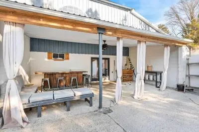 a patio with a bench in front of a building at Underground Railroad Barn in Kennett Square