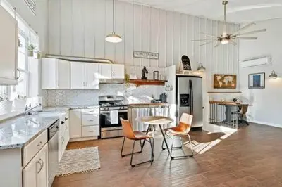 a kitchen with white cabinets and a table and chairs at Underground Railroad Barn in Kennett Square
