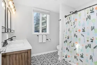 a bathroom with a shower curtain and a sink at Underground Railroad Barn in Kennett Square