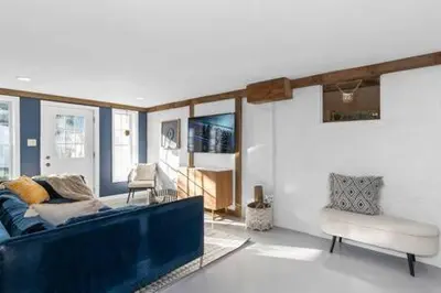 a living room with a blue couch and a chair at Underground Railroad Barn in Kennett Square