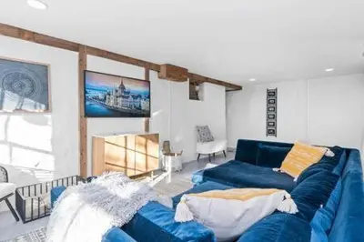 a living room with a blue couch in a room at Underground Railroad Barn in Kennett Square