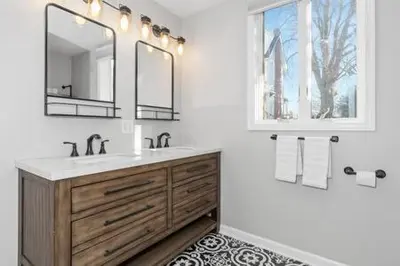 a bathroom with a sink and a mirror at Underground Railroad Barn in Kennett Square
