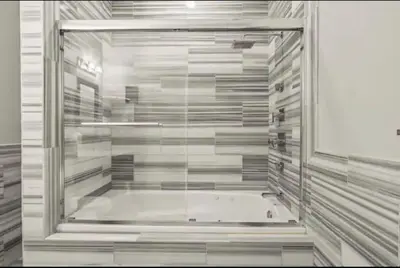 a walk in shower with a glass door at XL Studio -Deluxe Studio - Pool & Concierge in Philadelphia