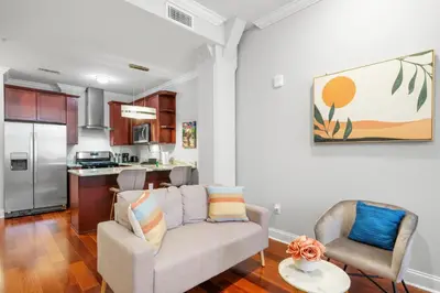 a living room with a couch and a kitchen at XL Studio -Deluxe Studio - Pool & Concierge in Philadelphia