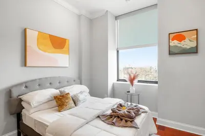 a bedroom with a bed and a window at XL Studio -Deluxe Studio - Pool & Concierge in Philadelphia