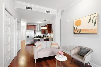 a living room with a couch and chairs and a kitchen at XL Studio -Deluxe Studio - Pool & Concierge in Philadelphia